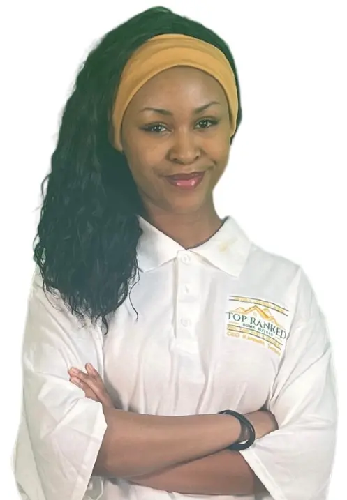Karissa Sesley, the Flip Daughter and Administrative Assistant, in a Polo Shirt, standing with arms folded with a smile